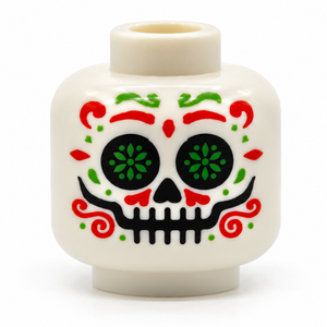 A white plastic toy head with a colorful sugar skull face design, featuring red, green, and black details on a white background.